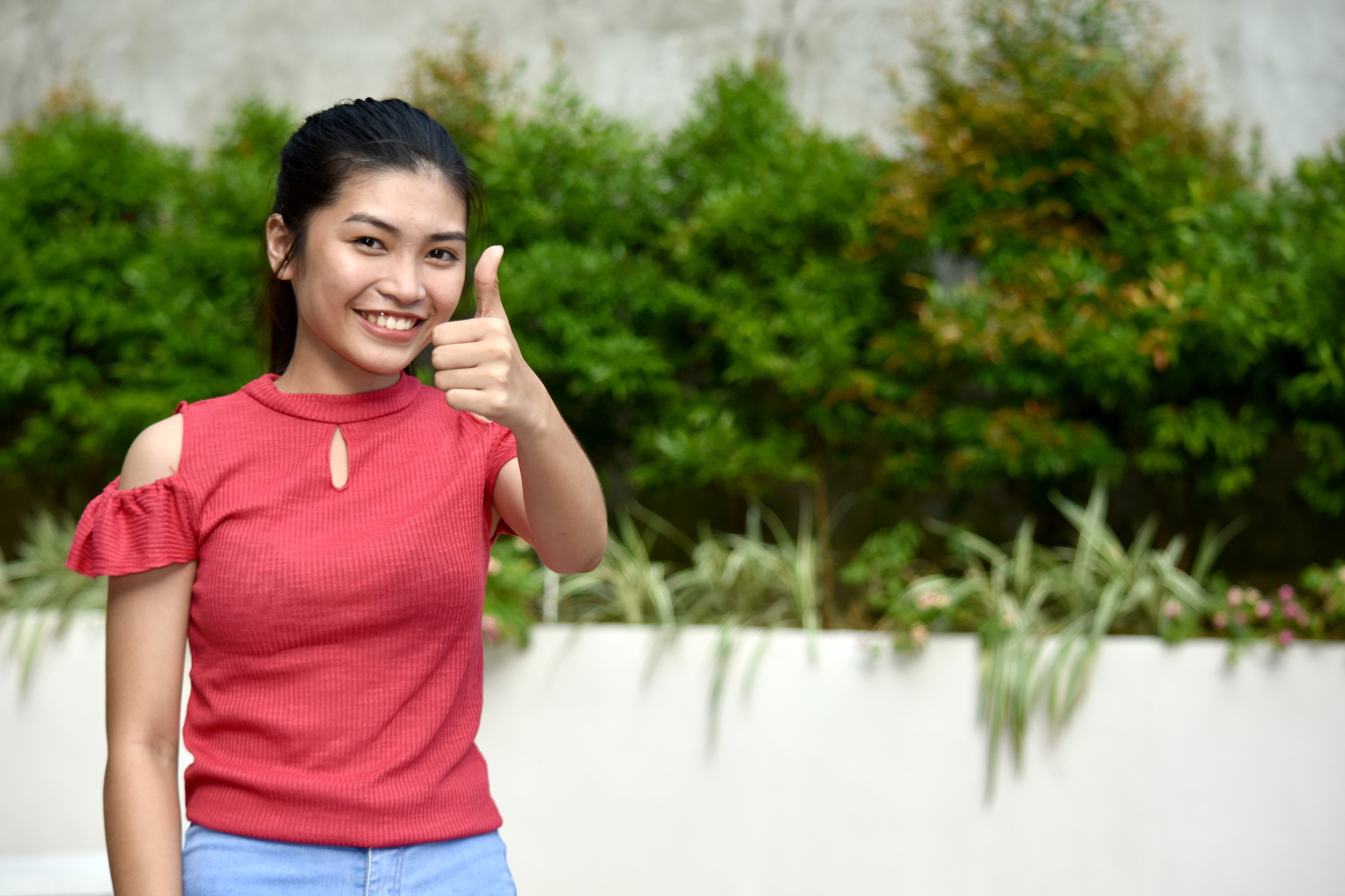 Youthful Diverse Girl With Thumbs Up